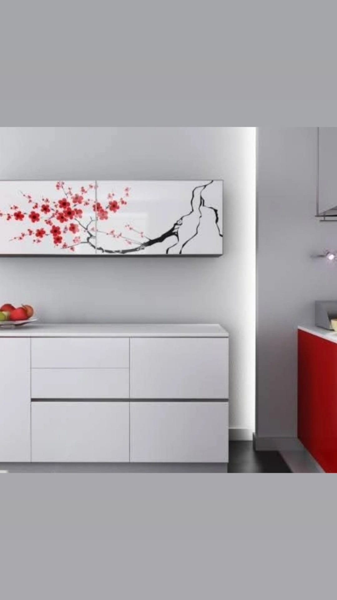 A sakura branch panel displayed above white furniture in a finished interior.